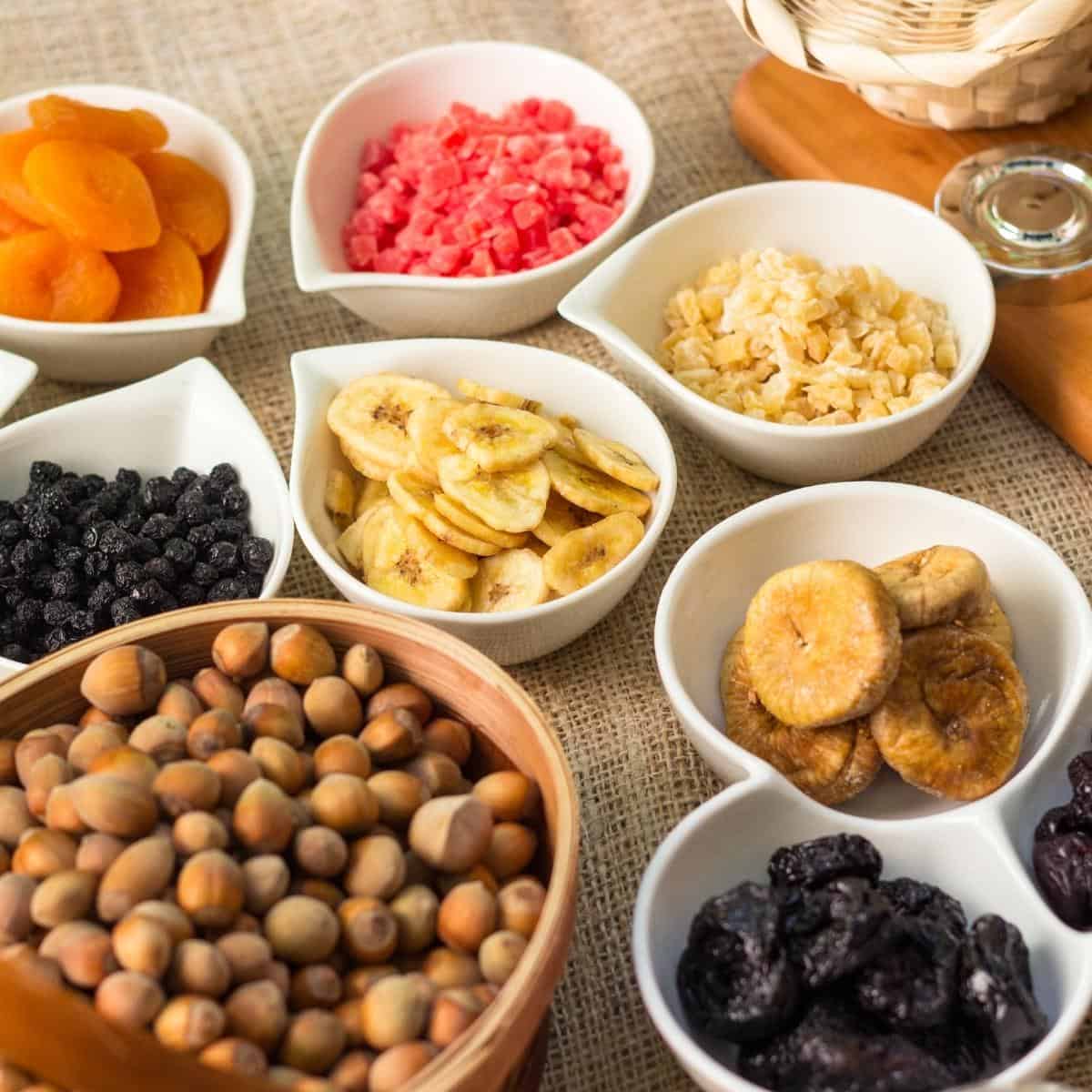 Small white bowls filled with dried fruit and nuts.