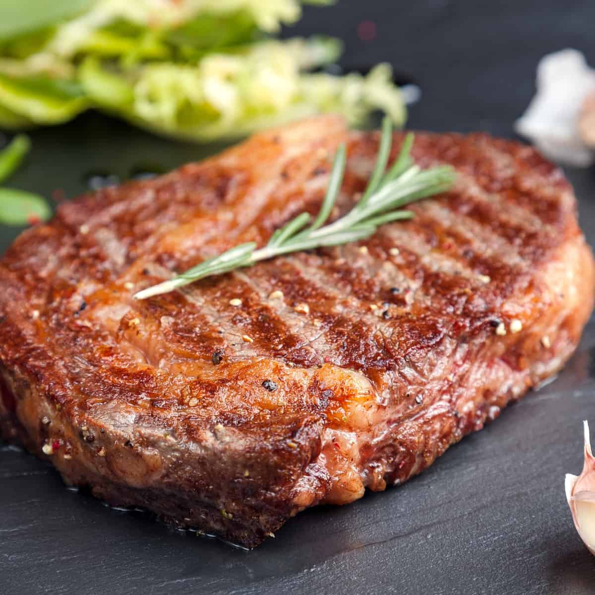 A pork chop cooked on a Blackstone griddle.