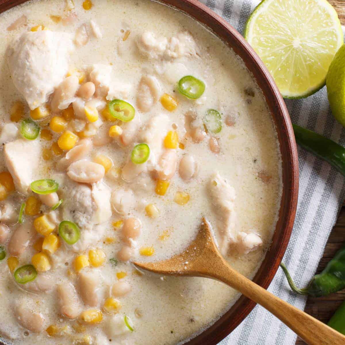 Creamy slow cooker chicken in a wooden bowl.